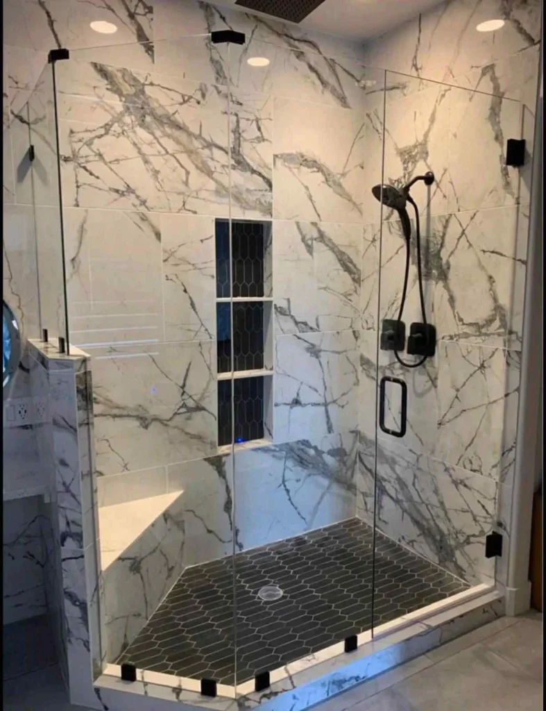 Elegant bathroom design showcasing a stylish shower area with marble walls.
