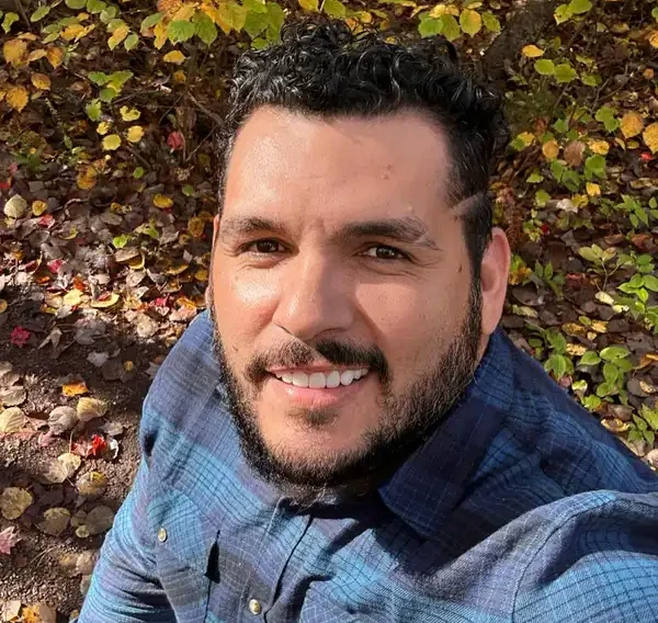 Portrait of Hernani Neto, owner of HN Builders Inc., smiling outdoors.Portrait of Hernani Neto, owner of HN Builders Inc., smiling outdoors.